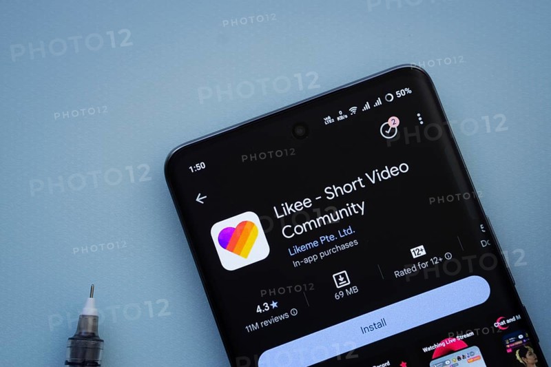 Dhaka, Bangladesh- 29 May 2025: On a blue surface, a smartphone displays the Likee app within the Google Play Store