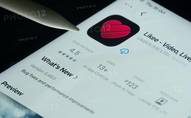 Dhaka, Bangladesh- 30 Oct 2025: Likee app on a iPad screen with a pen pointing at the install option