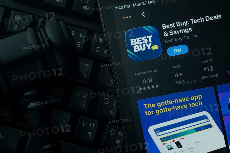 Dhaka, Bangladesh- 28 Oct 2025: An iPad displaying the Best Buy app against a judge's gavel and dark keyboard background