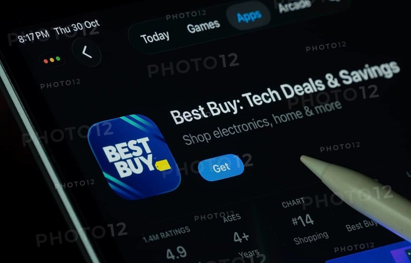 Dhaka, Bangladesh- 30 Oct 2025: Best Buy app displayed on a iPad screen in dark mode with a digital pen pointing at it