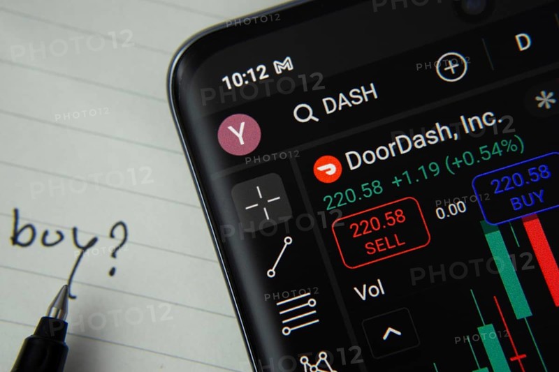 Dhaka, Bangladesh- 20 June 2025: DoorDash stock trading details displayed on smartphone with handwritten note
