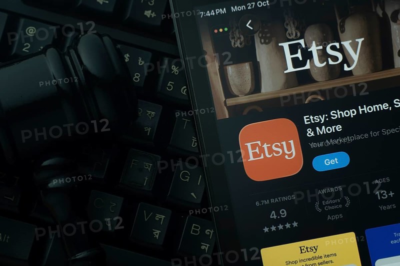Dhaka, Bangladesh- 28 Oct 2025: An iPad displaying the Etsy app against a judge's gavel and dark keyboard background