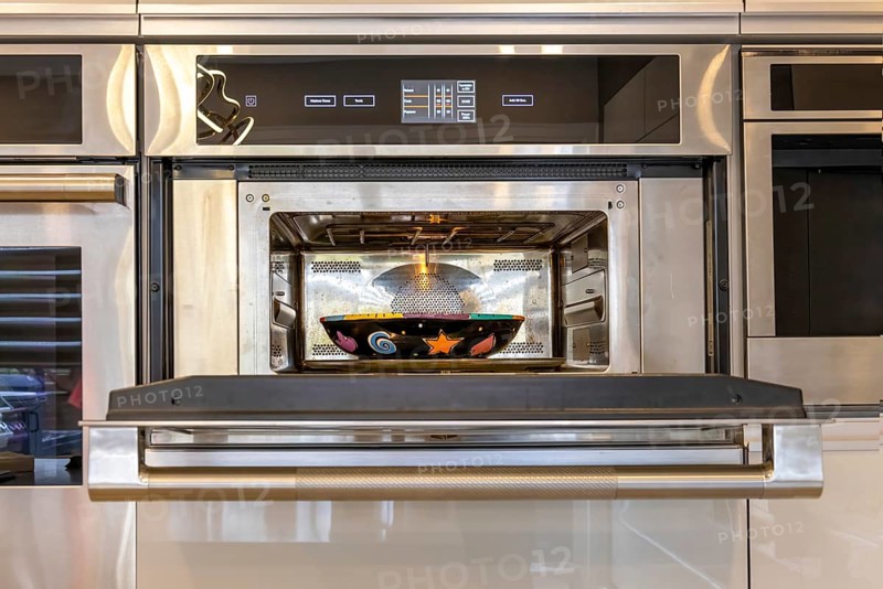 Modern kitchenware and microwave in luxury designer kitchen. Food preparation with expensive kitchen tools