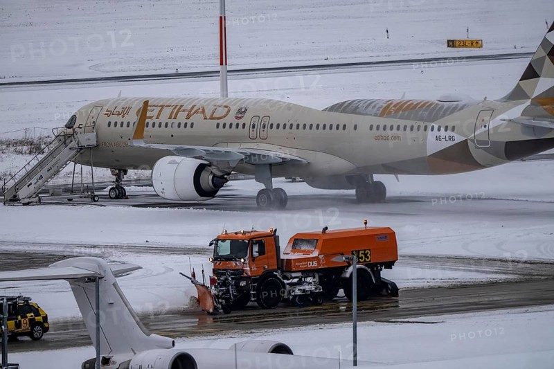 The onset of winter in North Rhine-Westphalia, flight operations are maintained at Düsseldorf airport with great effort, taxiways, runway are freed from snow and ice with many clearing vehicles, airplanes are de-iced in front of takeoff, North Rhine-Westphalia, Germany