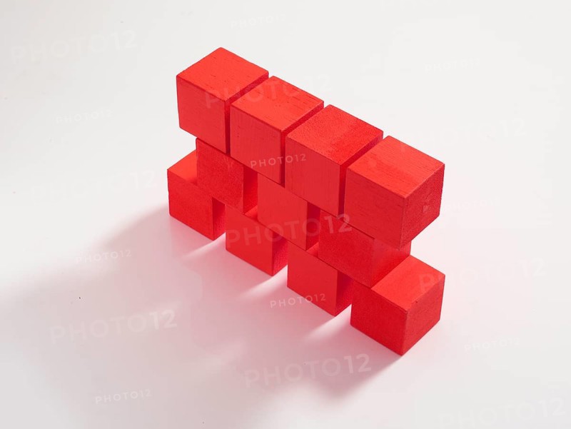 11 red wooden cubes against a white background