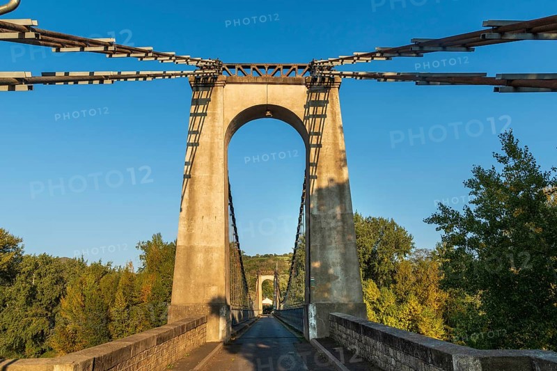 Suspension bridge of Coudes village on river Allier. Puy de Dome. Auvergne Rhone Alpes. France