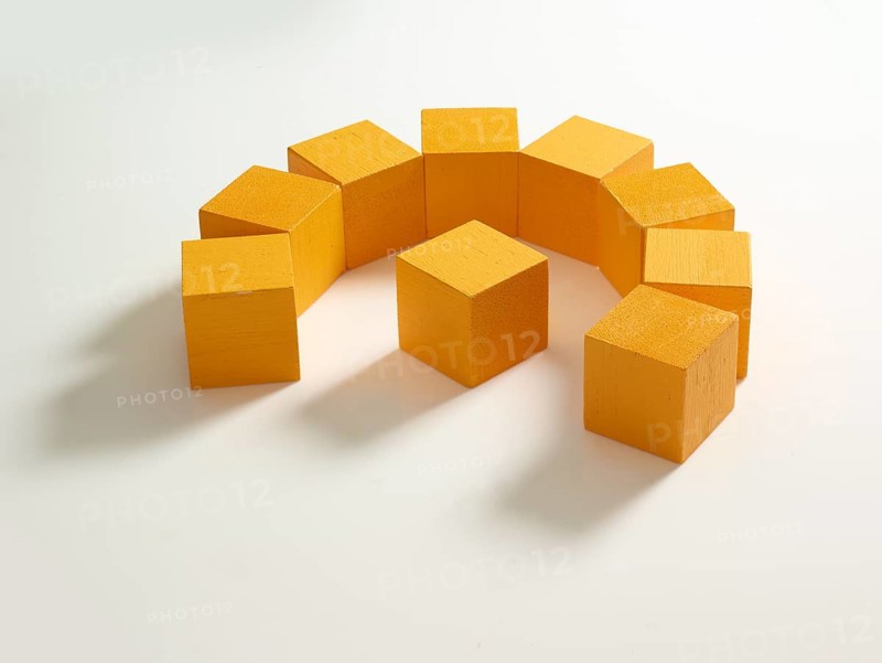 9 yellow wooden cubes against a white background