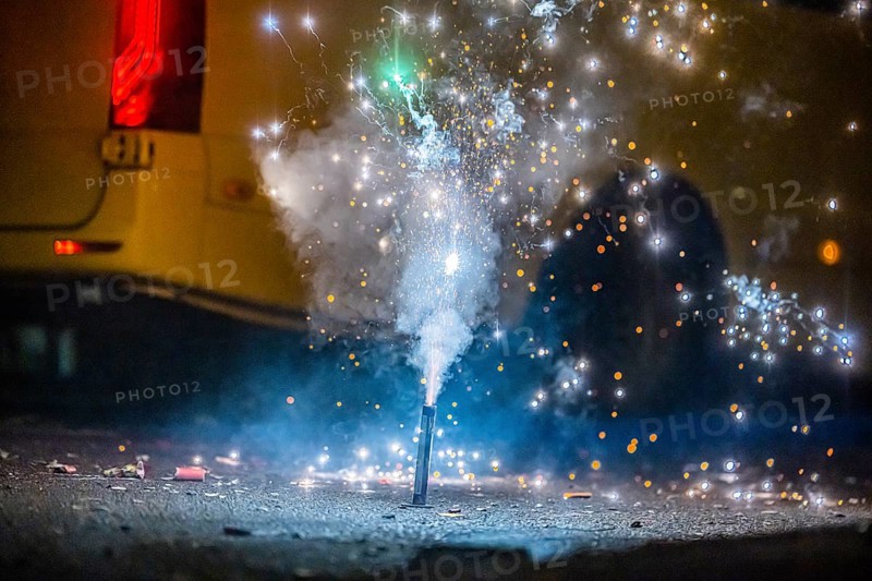 Burnt off fireworks are lying on the street, firecracker smoke produces smoke. New Year's night on a street in Stuttgart, Baden-Württemberg, Germany