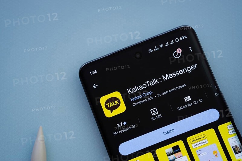 Dhaka, Bangladesh- 29 May 2025: On a blue surface, a smartphone displays the KakaoTalk app within the Google Play Store