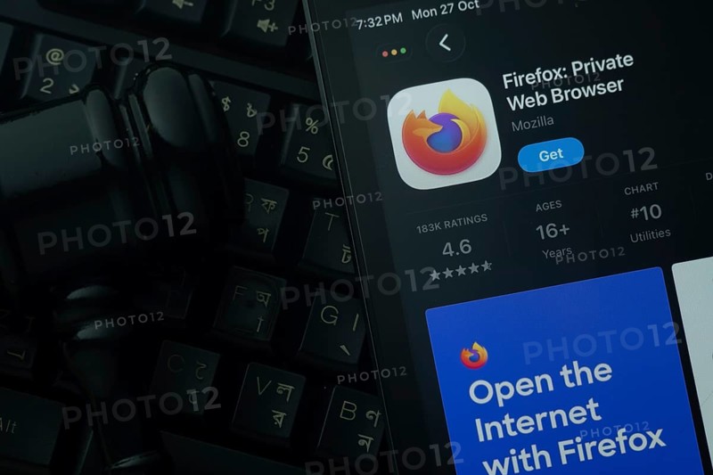Dhaka, Bangladesh- 28 Oct 2025: An iPad displaying the Firefox app against a judge's gavel and dark keyboard background