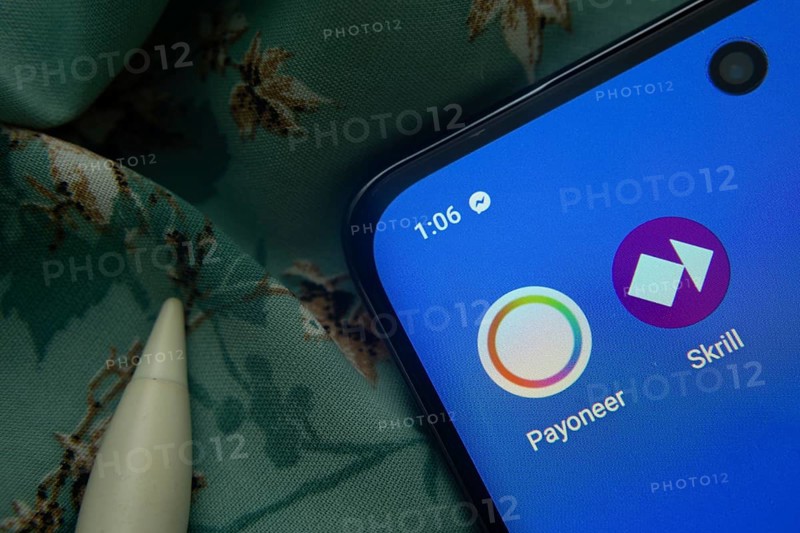 Dhaka, Bangladesh- 07 May 2025: Payoneer and Skrill app icon is seen on smartphone