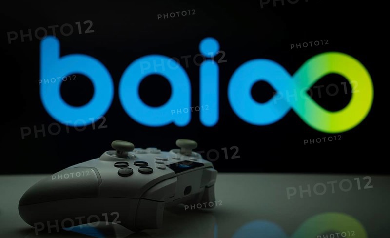 Dhaka, Bangladesh- 20 Mar 2025: A close-up of a white gamepad with the Baioo Family Interactive Ltd seen on screen in the background