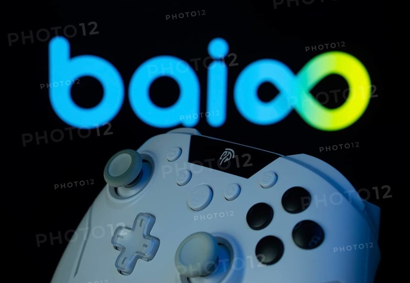 Dhaka, Bangladesh- 20 Mar 2025: A close-up of a gamepad with the Baioo Family Interactive Ltd seen on screen in the background