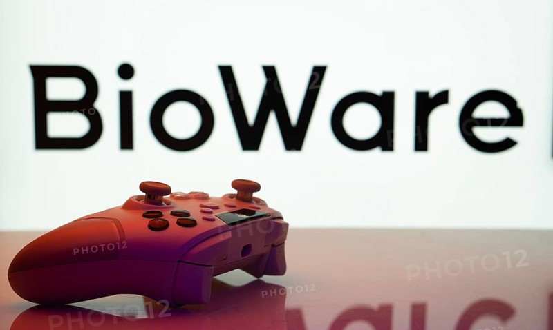 Dhaka, Bangladesh- 20 Mar 2025: A close-up of a white gamepad with the BioWare seen on screen in the background