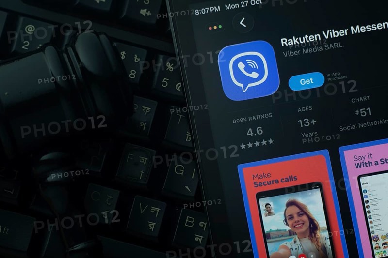 Dhaka, Bangladesh- 28 Oct 2025: An iPad displaying the Rakuten Viber app against a judge's gavel and dark keyboard background
