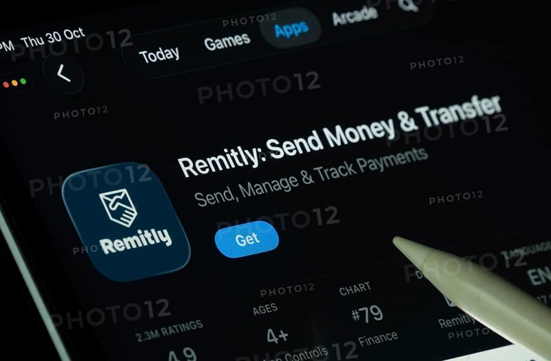 Dhaka, Bangladesh- 30 Oct 2025: Remitly app displayed on a iPad screen in dark mode with a digital pen pointing at it