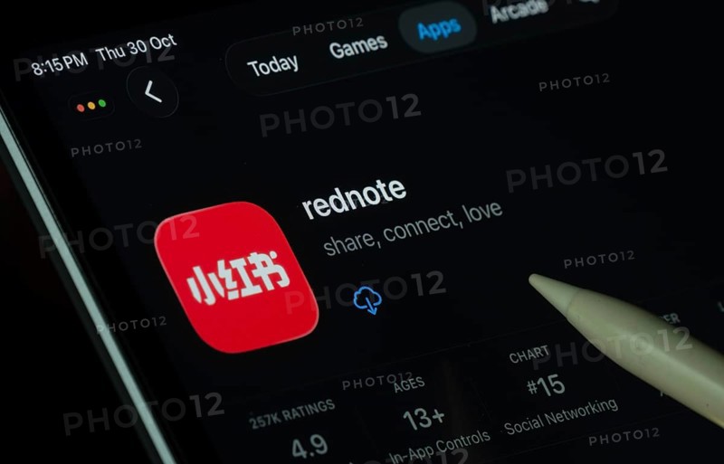 Dhaka, Bangladesh- 30 Oct 2025: rednote app displayed on a iPad screen in dark mode with a digital pen pointing at it