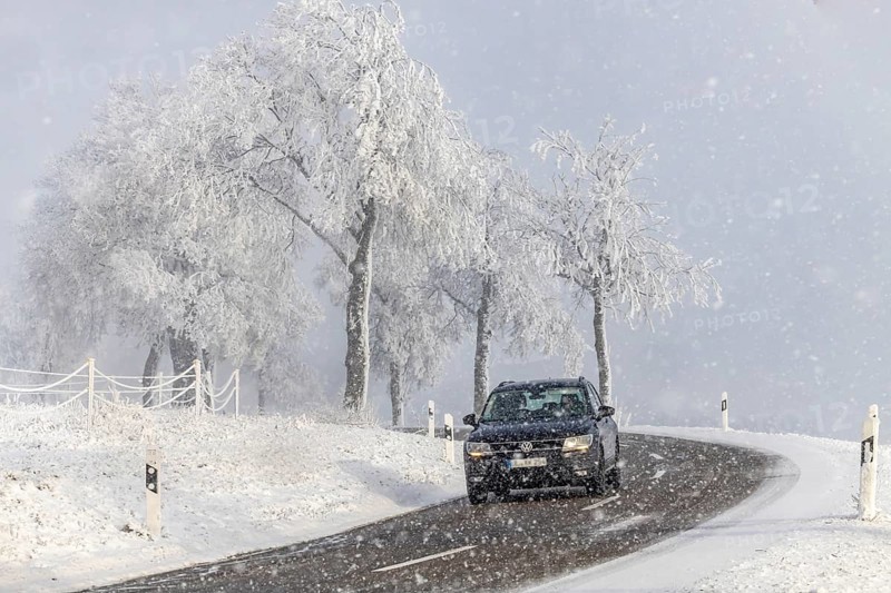 Winter in the Swabian Jura. Country road with snowy landscape near Westerheim, Alb-Donau-Kreis, Baden-Württemberg, Germany
