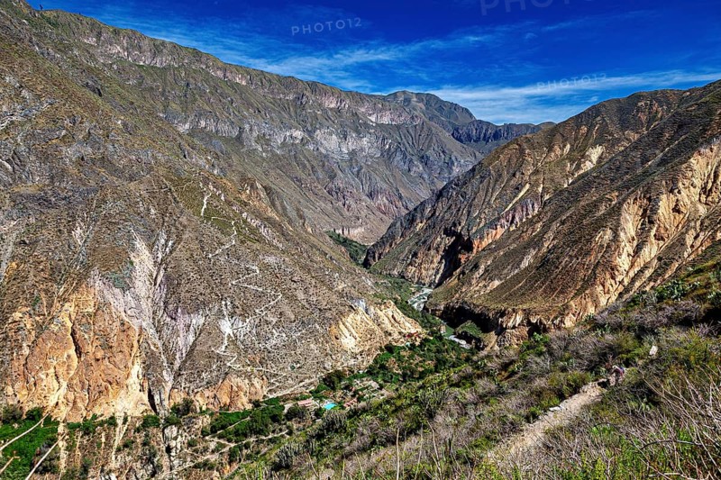 Extensive mountain landscape with a deep gorge under blue sky, The landscape of Colca Canyon in the Aden of Peru