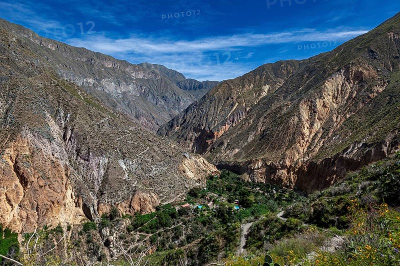 Mountainous landscape under clear skies with a deeply cut gorge, The landscape of Colca Canyon in the Aden of Peru