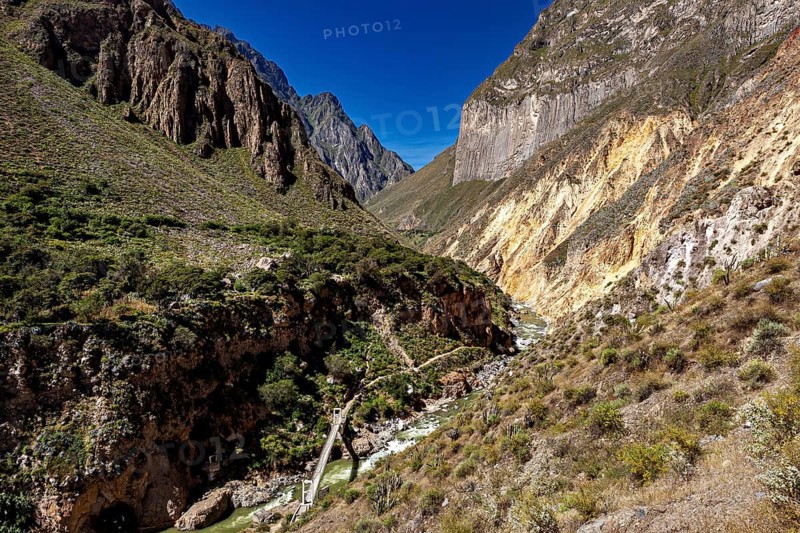 Impressive gorge landscape with winding river and surrounding steep mountain walls, The landscape of Colca Canyon in the Aden of Peru