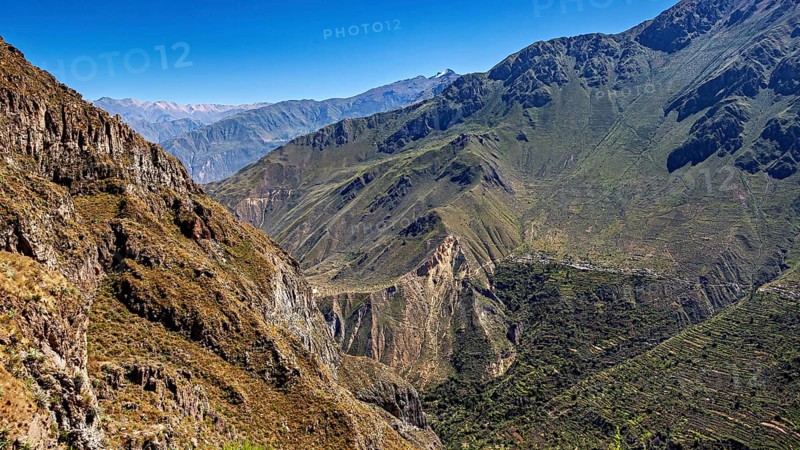 Extensive mountain landscape with green hills under sunny skies, the landscape of Colca Canyon in the Aden of Peru