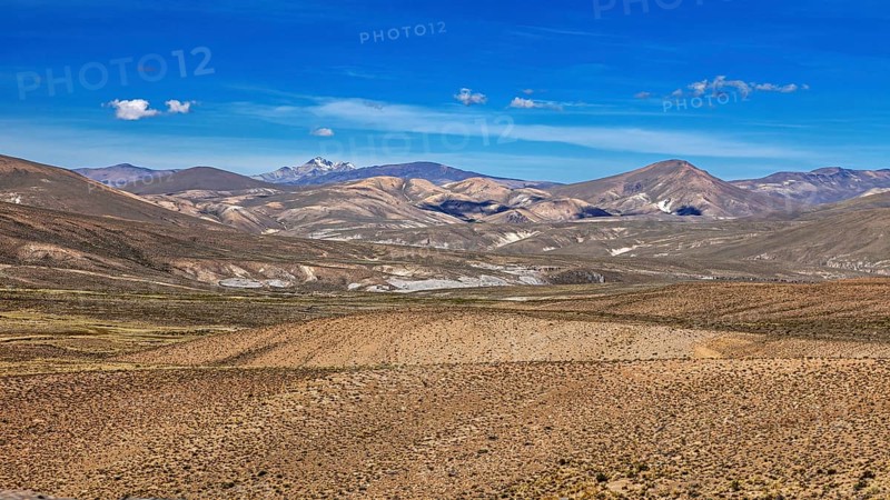 Pristine vast landscape with rolling desert under blue sky, The Andean highlands of Peru
