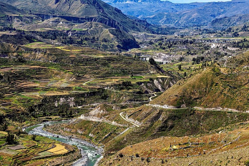 Wide views of terraced hills and flowing river, the landscape of Colca Canyon in the Aden of Peru