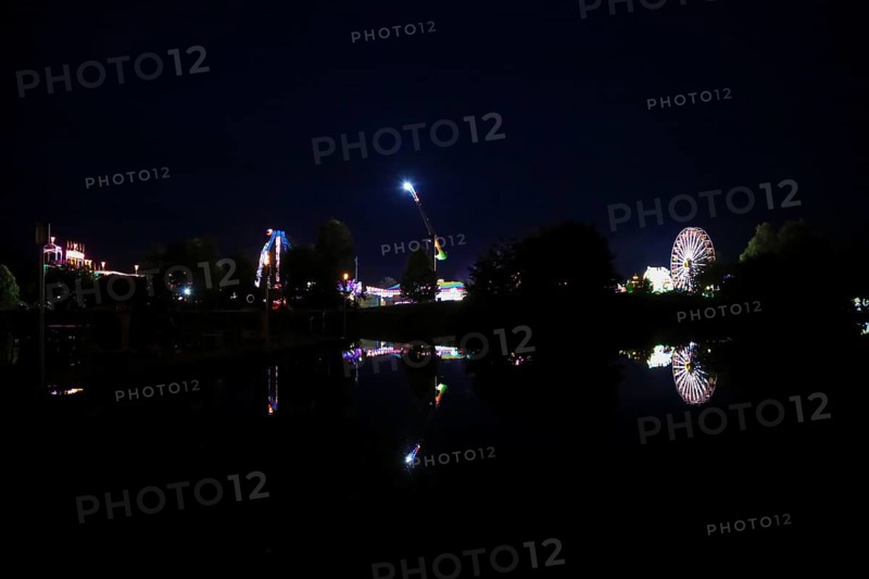 Fairground in Ulm Friedrichsau at night, folk festival, hustle and bustle, fair, Ferris wheel, amusement park, amusement attraction, ride, artificial light, darkness, reflection in natural lake, Ausee, Ferris wheel, Ulm, Baden-Württemberg, Germany