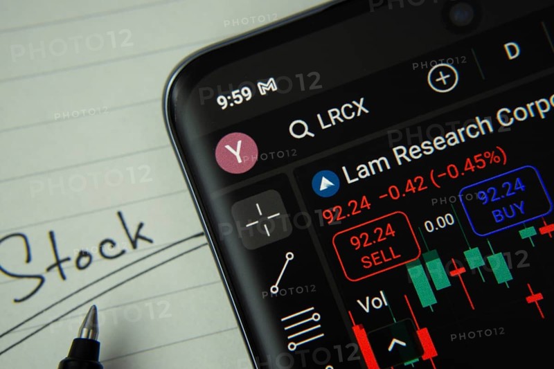 Dhaka, Bangladesh- 20 June 2025: Lam Research stock trading information on smartphone screen with a handwritten note
