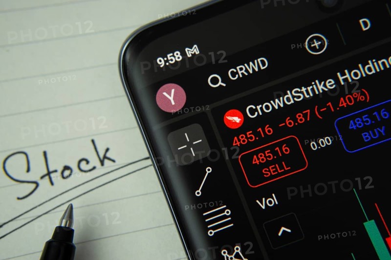 Dhaka, Bangladesh- 20 June 2025: CrowdStrike stock trading information on smartphone screen with a handwritten note