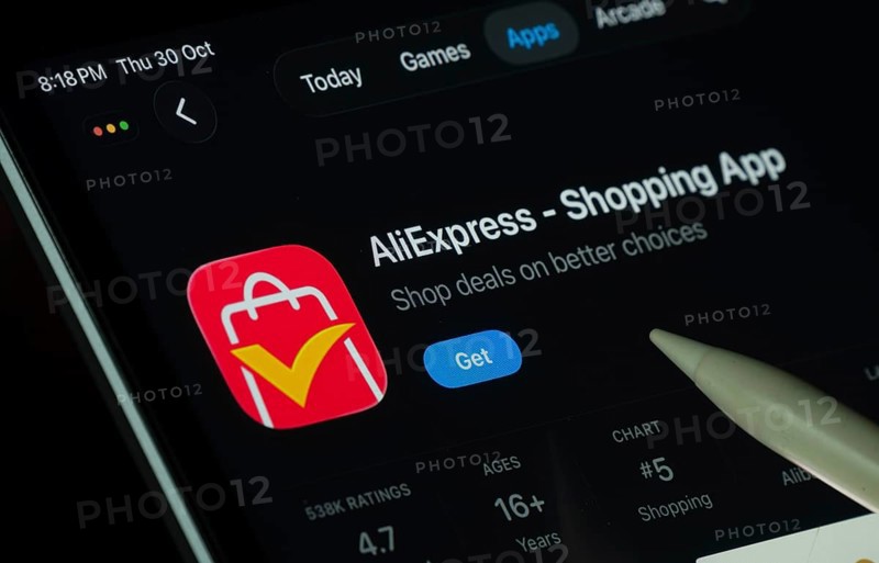 Dhaka, Bangladesh- 21 Nov 2025: AliExpress app displayed on a iPad screen in dark mode with a digital pen pointing at it