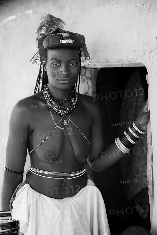 Black and white, portrait, brightly decorated woman of the Hakaona tribe, also Havakona or Hakawona, near Opuwo, Kunene, Namibia