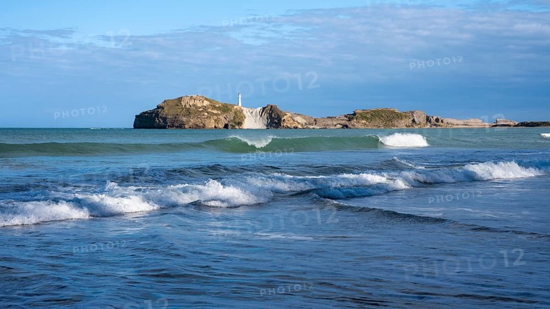 Castlepoint Beach and Castlepoint Lighthouse, ocean, waves, surf, sandy beach, rocks. Castlepoint, Wairarapa Coast, Wellington Region, North Island, New Zealand