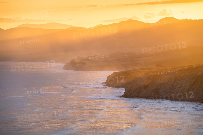 Wairarapa coast at sunset. Sea, mountains, backlight. Castlepoint, Wairarapa Coast, Wellington Region, North Island, New Zealand