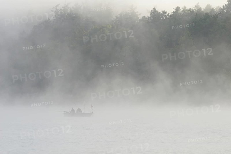 Hennesee, fog, rising clouds of fog, anglers in the boat, Hennetalsperre, Sauerland-Rothaargebirge nature park Park, North Rhine-Westphalia, Germany