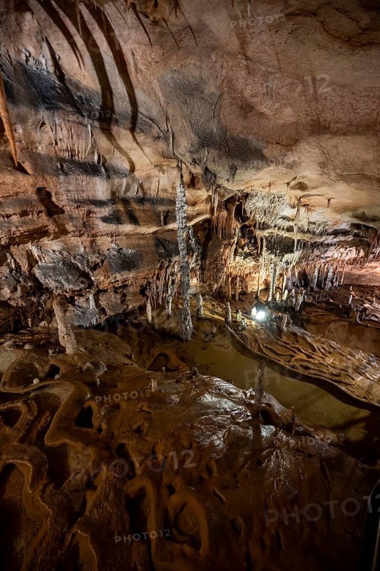 Stalactites and stalagmites, rock formations in a stalactite cave with water basin, Grotta del Fico, Gulf of Orosei, Baunei, Sardinia, Italy