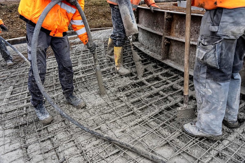 Concreting, concreting the foundation of a wind turbine, concrete pump hose, compressor, more than 600 cubic meters of concrete will be pumped into the foundation for over 7 hours, over 100 tons of reinforcing steel have been used, the wind turbine will have a hub height of 160 meters, part of a new wind farm in Sauerland, near Balve, North Rhine-Westphalia, Germany