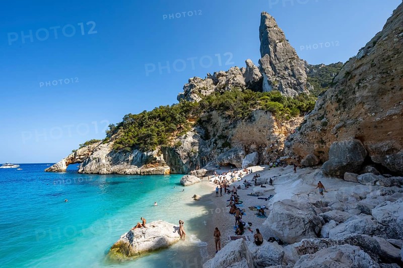 Light blue clear sea on a dream beach on Cala Goloritzé, picturesque rocky coast, steep coast with rock pin L'Aguglia, Golfo di Orosei, Baunei, Sardinia, Italy