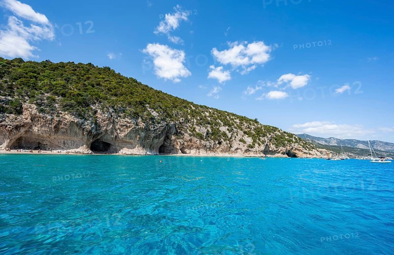 Clear blue water and picturesque rocky coast, Cala Luna cliffs and beach, Golfo di Orosei, Baunei, Sardinia, Italy