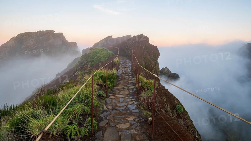 Sunrise at Pico do Arieiro, clouds of fog sweep over mountain peaks, sea of fog, hiking trail PR1, Madeira, Portugal