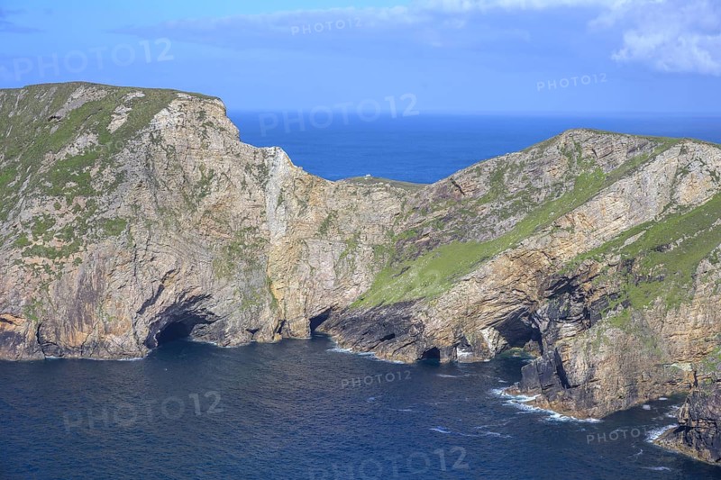 View of blue sea and cliffs with rock gate from Portacloy Loop Cliff Walk, Muingnabo, County Mayo, Ireland