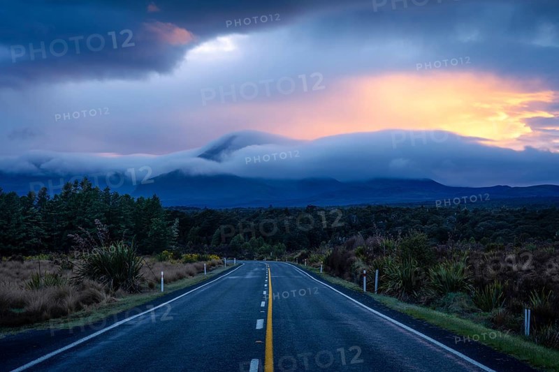 Mount Ngauruhoe in the morning at sunrise with glowing clouds, road SH 47. Tongariro National Park, North Island, New Zealand