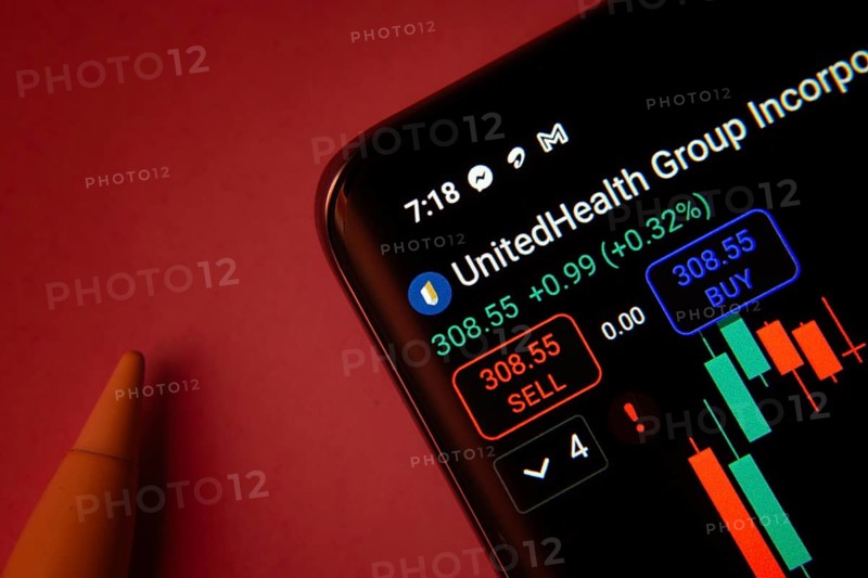 Dhaka, Bangladesh- 08 Sep 2025: Close-up of a phone screen showing UnitedHealth Group Incorporated stock market data with a candlestick chart