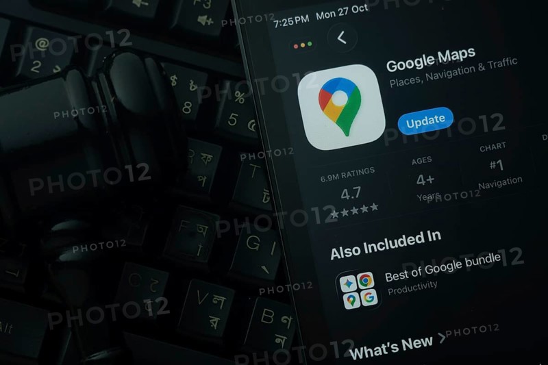 Dhaka, Bangladesh- 28 Oct 2025: An iPad displaying the Google Maps app against a judge's gavel and dark keyboard background