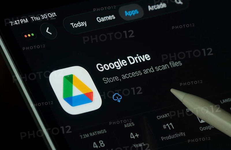 Dhaka, Bangladesh- 30 Oct 2025: Google Drive app displayed on a iPad screen in dark mode with a digital pen pointing at it