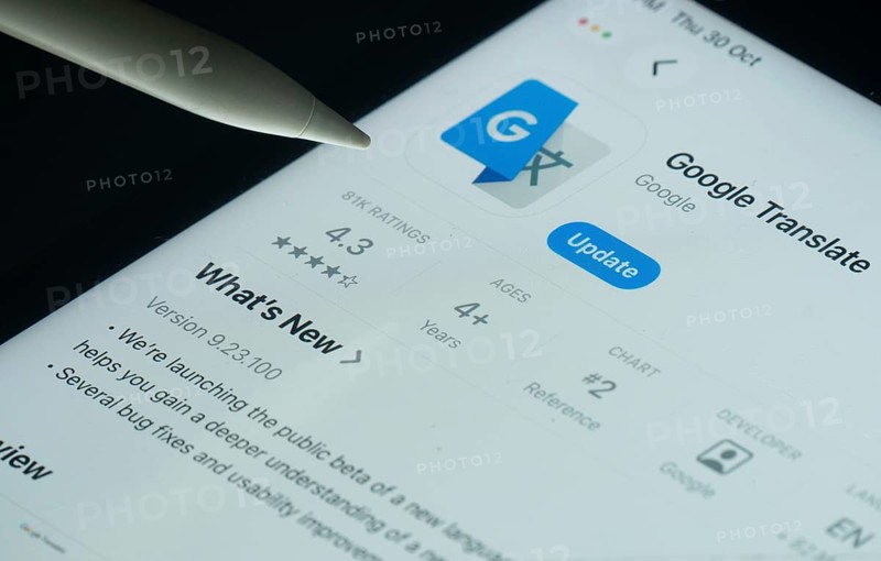 Dhaka, Bangladesh- 30 Oct 2025: Google Translate app on a iPad screen with a pen pointing at the install option