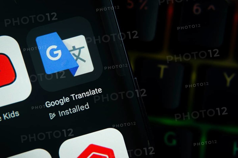 Dhaka, Bangladesh- 27 July 2025: Close-up of smartphone screen showing the Google Translate app icon with a dark interface
