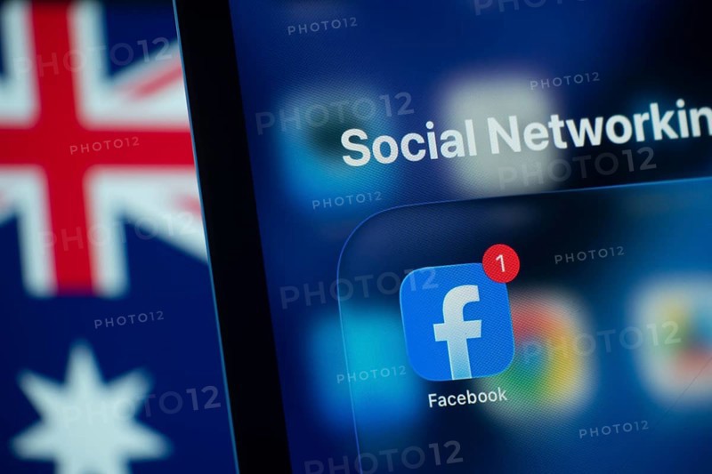 Dhaka, Bangladesh- 01 Dec 2025: A smartphone screen displays the Facebook app with an Australian flag in the background