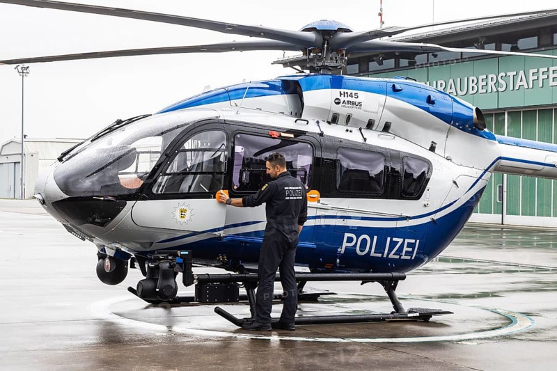 Helicopter from the Baden-Württemberg Police team in front of the hangar at the airport. Airbus Helicopters H145. Stuttgart, Baden-Württemberg, Germany